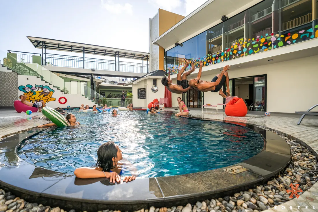 Guests in the pool, someone mid-dive