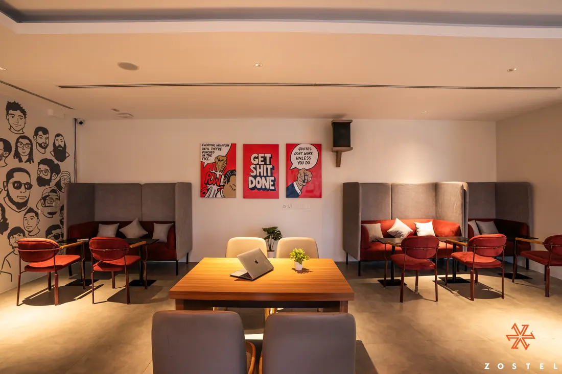 Workation desks in front of the drawn-faces wall